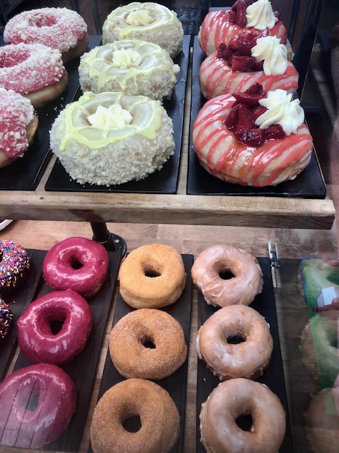 Tray of colorfully decorated donuts