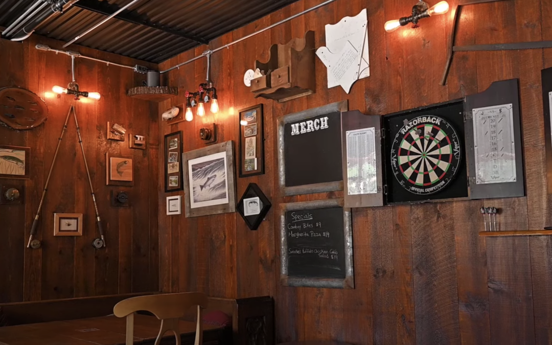 Inside of a pub with wood grain walls and dart board