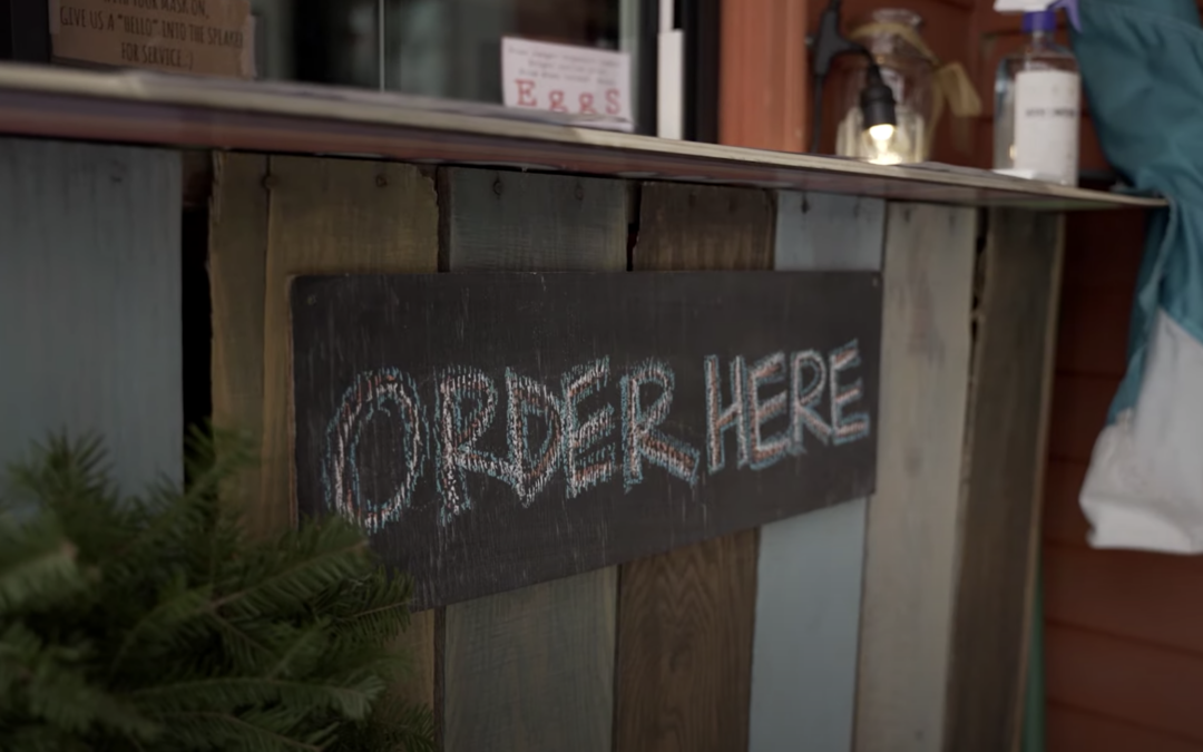 Wooden sign that reads "order here"