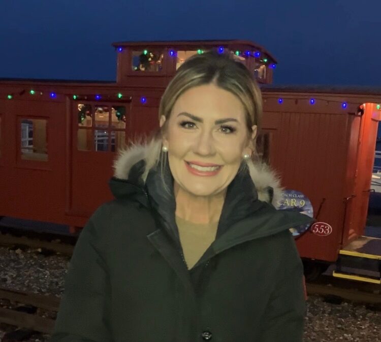 Erin Ovalle smiling in front of a train car