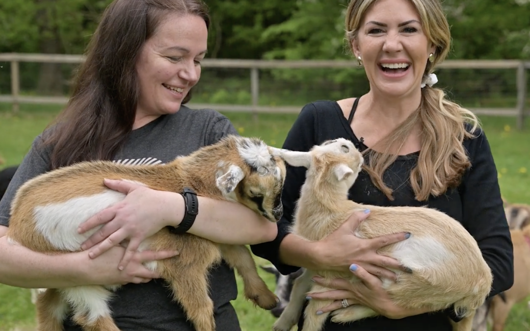 Michelle and Erin with baby goats at Sunflower Farm